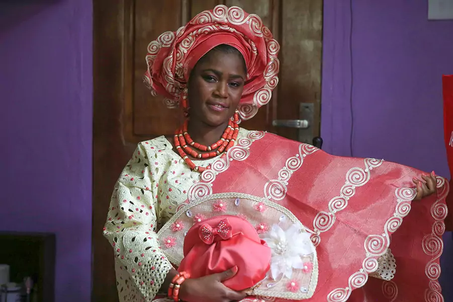 Sunlola Ogungbadero, dressed in traditional attire, poses for a photograph before the start of her traditional wedding in Surulere district, Lagos, Nigeria, on July 31, 2014.