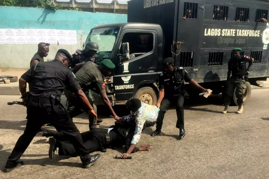Police officers pull a journalist during an anti-government protest in Lagos, Nigeria August 5, 2019. 