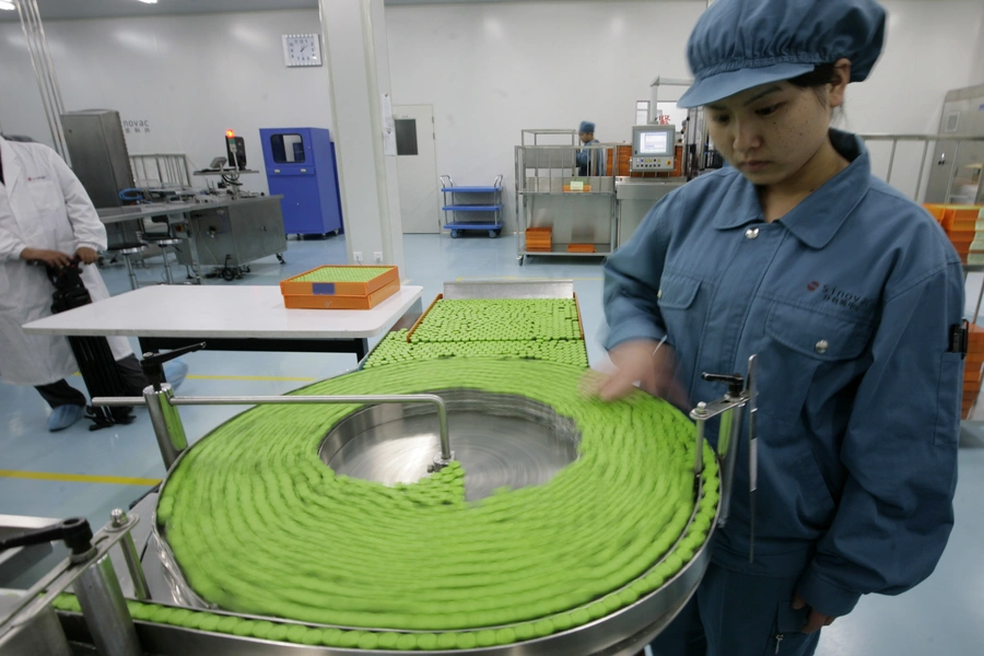 A technician works at a product line of the Inactivated H1N1 Influenza Vaccine in Sinovac Biotech Ltd., a Chinese vaccine making company, in Beijing, September 3, 2009. 