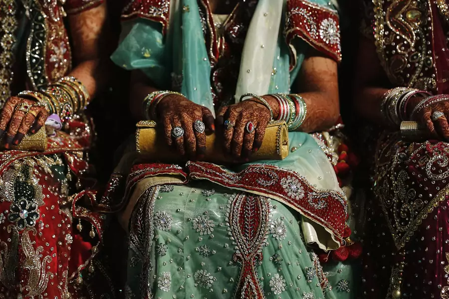 Muslim brides wait for the start of their mass marriage ceremony in Mumbai, India. May 11, 2014.