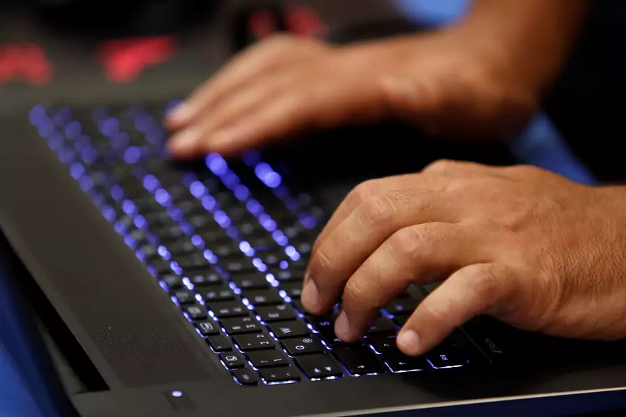 A man types into a keyboard during a hacker convention on July 29, 2017. 