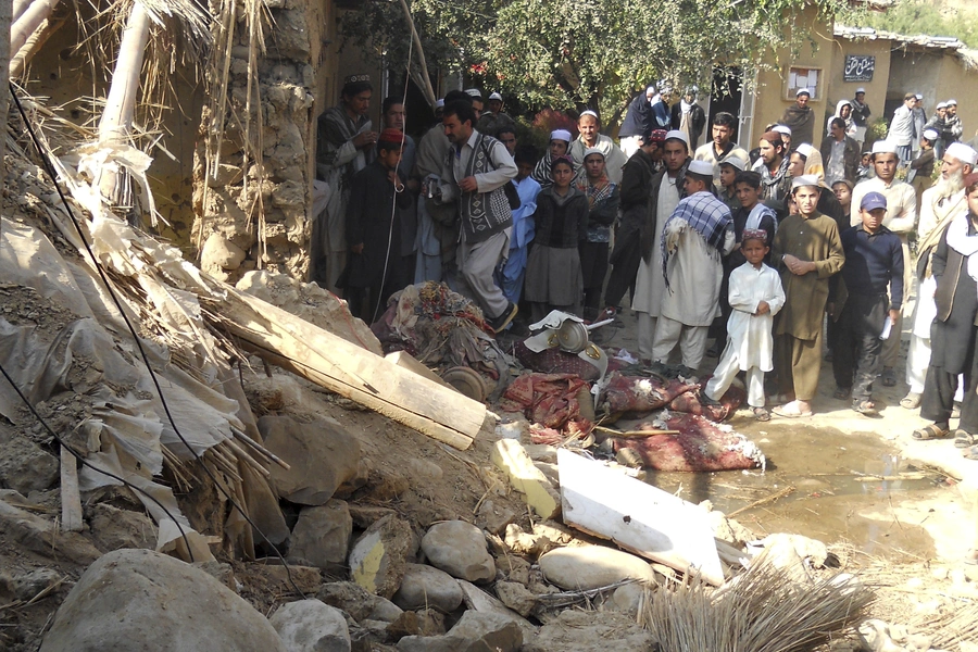 Students at the site of a suspected U.S. drone strike in Khyber Pakhtunkhwa, Pakistan, in 2013.  The strike killed a senior member of the Haqqani network.