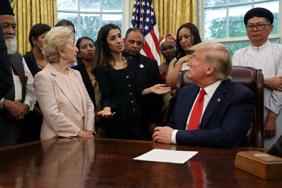 President Donald J. Trump listens to Nadia Murad as he hosts a group of victims of religious persecution in the Oval Office of the White House. Washington, DC, United States. July 17, 2019.