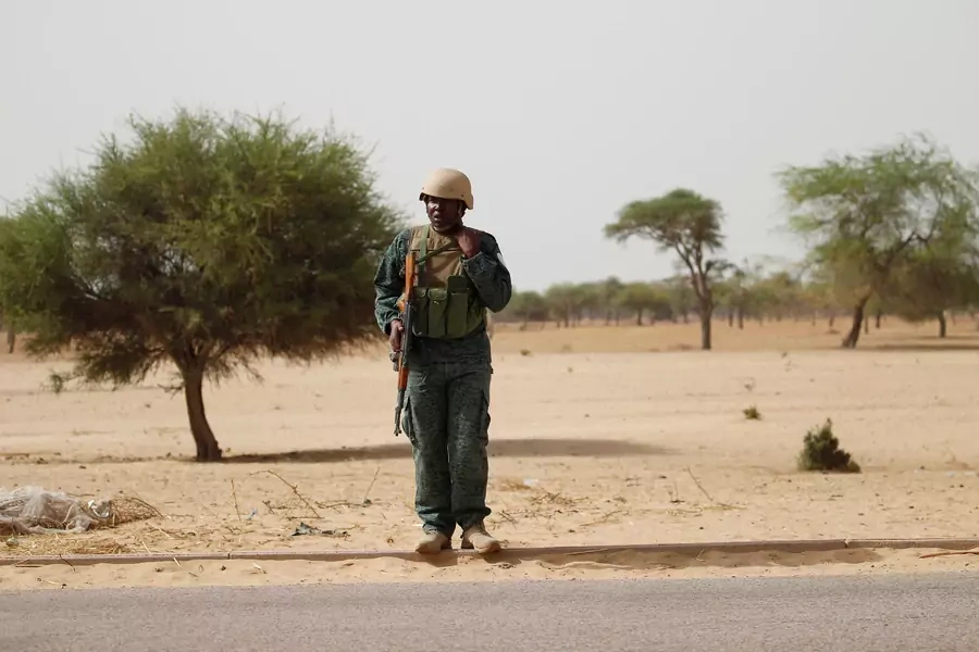 A Nigerien soldier stands guard near the city of Diffa, Niger, far to the east of Niger's border with the Nigerian states of Katsina, Sokoto, and Zamfara, on June 18, 2016.  
