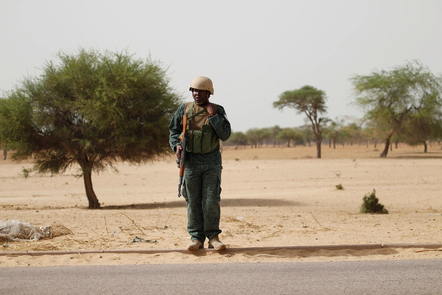 A Nigerien soldier stands guard near the city of Diffa, Niger, far to the east of Niger's border with the Nigerian states of Katsina, Sokoto, and Zamfara, on June 18, 2016.  