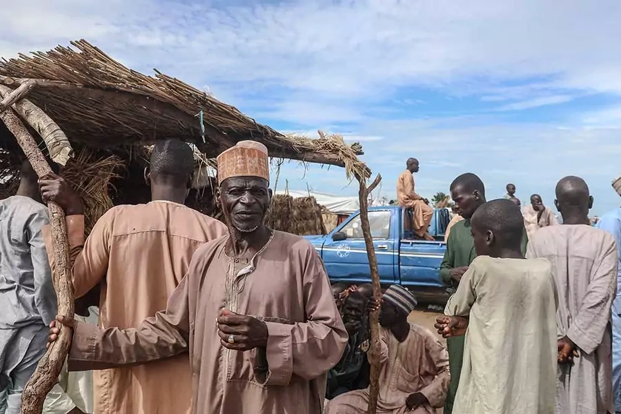 Internally displaced persons gather at the Muna camp in Maiduguri, on July 21, 2019.