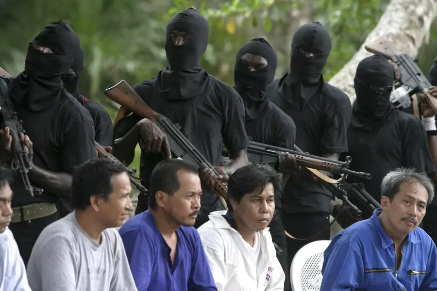 Filipino hostages guarded by militants of the Movement for the Emancipation of Niger Delta (MEND) in the Niger delta on January 31, 2007. Kidnapping was a common tool used by such militants for political ends, but nationwide kidnapping is more criminal.