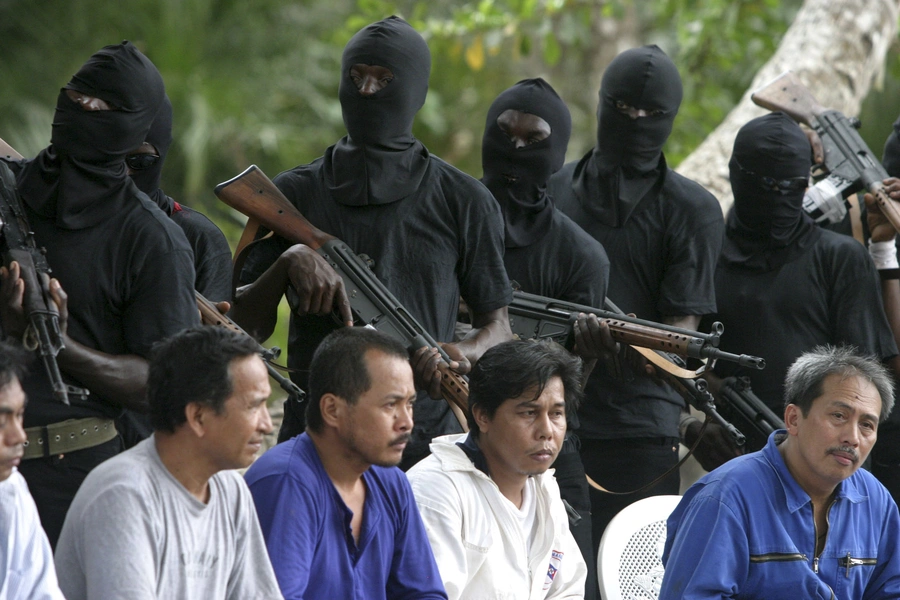 Filipino hostages guarded by militants of the Movement for the Emancipation of Niger Delta (MEND) in the Niger delta on January 31, 2007. Kidnapping was a common tool used by such militants for political ends, but nationwide kidnapping is more criminal.