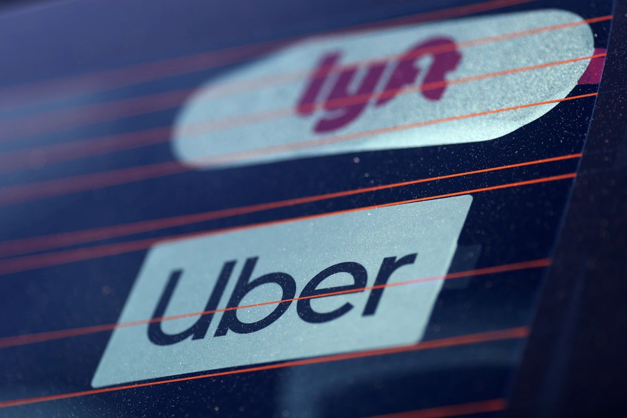 Uber and Lyft signs are seen on a car in Redondo Beach, California, U.S., March 25, 2019.