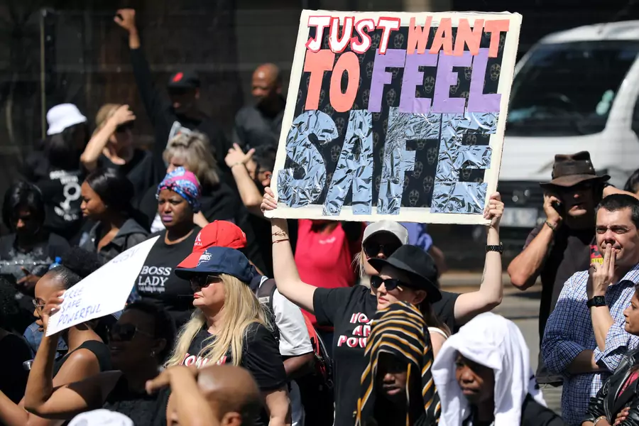 Demonstrators hold placards as they protest against gender-based violence, outside the Johannesburg Stock Exchange in Sandton, Johannesburg, South Africa, on September 13, 2019.