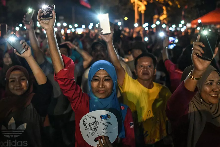 Opposition supporters turn on flashlights on their phones after former Malaysian Prime Minister Mahathir Mohamad was elected as a parliamentary constituency candidate during a rally ahead of the 14th general election in Malaysia on April 15, 2018.