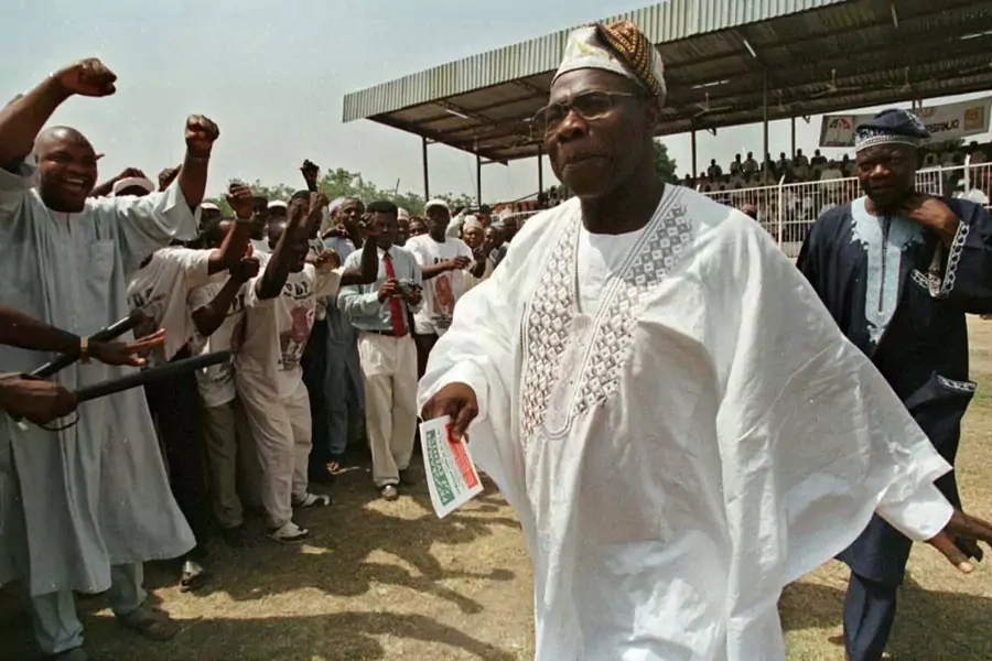 Presidential candidate for the People's Democratic Party Olusegun Obasango (r) walks through a cheering crowd during a rally in Minna, the capital of northern Niger state, on February 22, 1999.