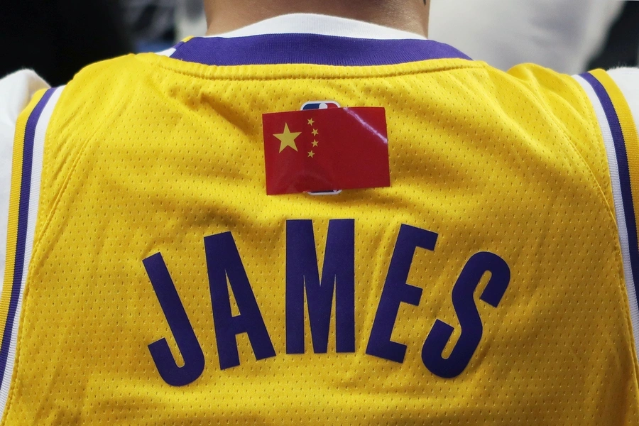  A fan is seen wearing a LeBron James jersey with an NBA logo covered by a Chinese national flag sticker during the game.