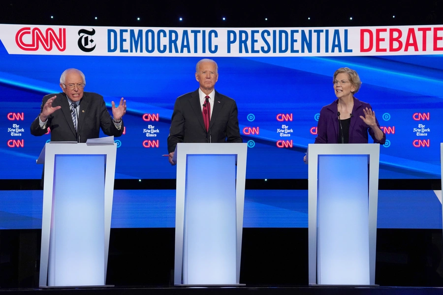 Democratic presidential candidate Senator Bernie Sanders (L), former Vice President Joe Biden, and Senator Elizabeth Warren (R) debate during the fourth Democratic presidential debate in Ohio on October 15.