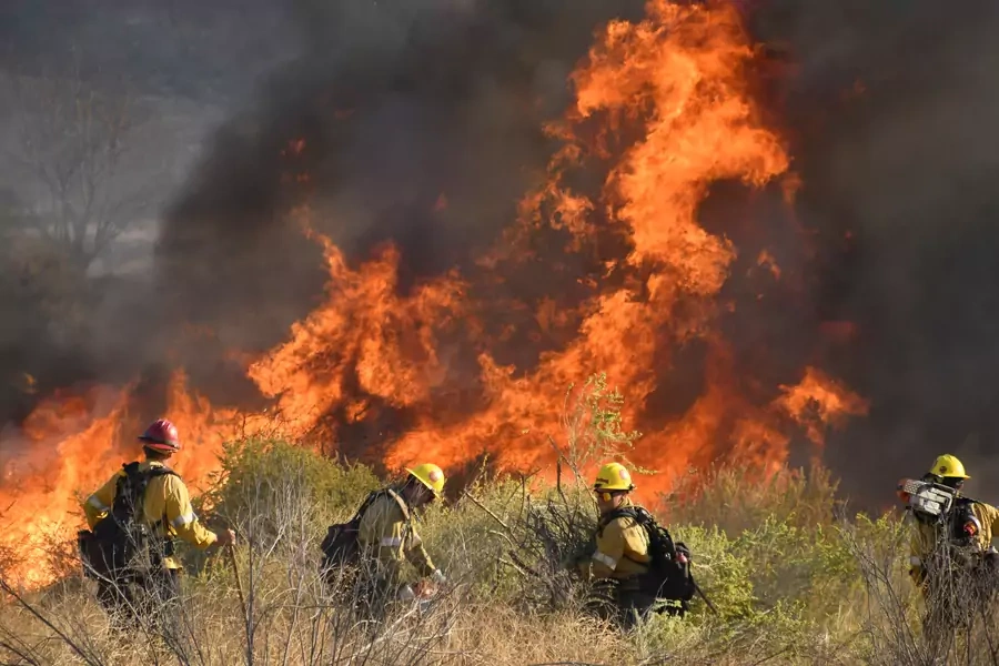 Firefighters battle a wildfire north of Los Angeles on October 25. 