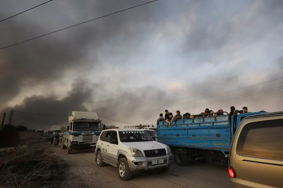 People flee Turkish airstrikes in the Kurdish-held border town of Ras al Ain on October 9.