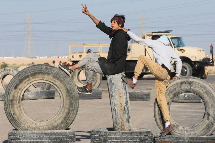 Iraqi demonstrators block the entrance of Khor al-Zubair commodities port during the ongoing anti-government protests, near Basra, Iraq November 19, 2019.