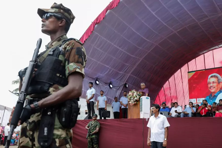 A soldier stands guard at a campaign rally for Gotabaya Rajapaksa, at podium, in Bandaragama earlier this month.