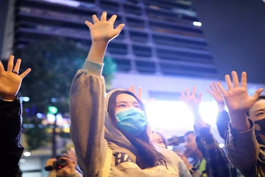 Protesters raise their hands outside the Polytechnic University in Hong Kong on November 25, 2019. 