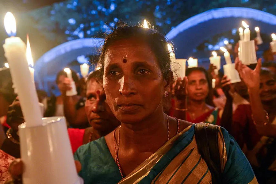 A woman at a candlelight vigil in Colombo, Sri Lanka in 2017, in remembrance of the minority Tamils missing since the Sri Lankan civil war ended in 2009.