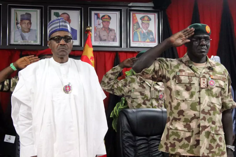 Nigerian president Muhammadu Buhari stands next to Chief of Army Staff Tukur Yusuf Buratai during the opening ceremony of the military staff annual conference, on November 28, 2018, during his trip to visit troops fighting Boko Haram.