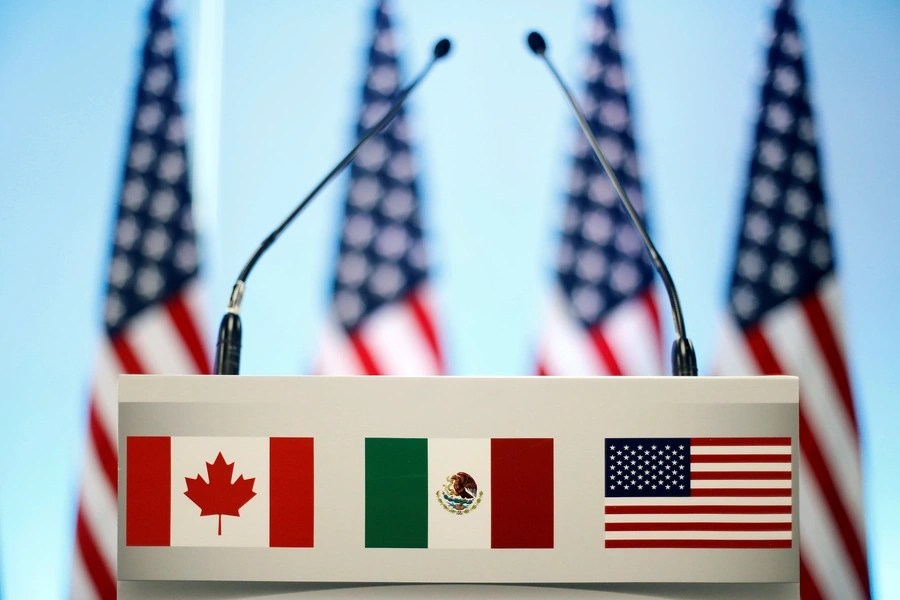 The flags of Canada, Mexico, and the U.S. are seen on a lectern before a joint news conference on the closing of the seventh round of NAFTA talks in Mexico City, Mexico.