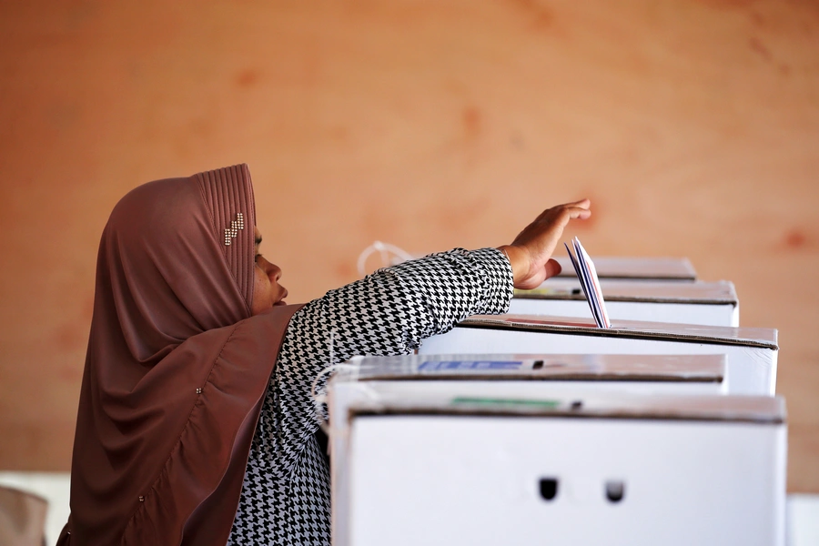 A voter casts her ballot during elections in Bogor, West Java, Indonesia on April 17. Willy Kurniawan/REUTERS