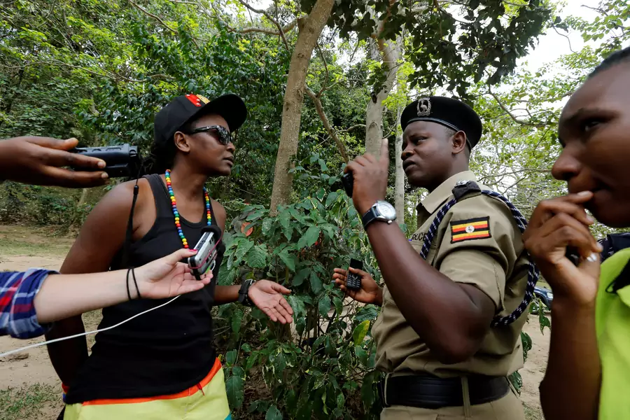 Uganda police officers question a member of Uganda's LGBT community during their pride parade in Entebbe, near  Kampala, before police asked LGBT members to abandon their gathering, on September 24, 2016.