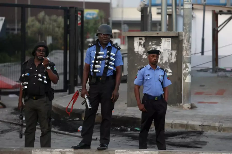 Three armed police officers stand in front of the Novare Shoprite Mall in Lekki, near Lagos, Nigeria, after it was looted, on September 3, 2019.