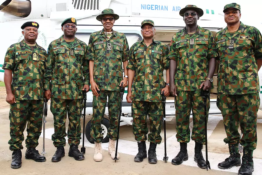  President Mohammadu Buhari poses with Nigeria's senior military officers during the Army Day celebration in Dansadau, northwest Nigerian Zamfara State, on July 13, 2016.