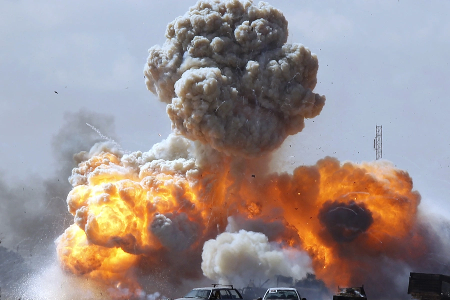 Vehicles belonging to Qaddafi forces explode after an air strike by coalition planes along a road between Benghazi and Ajdabiya on March 20, 2011. Goran Tomasevic/Reuters