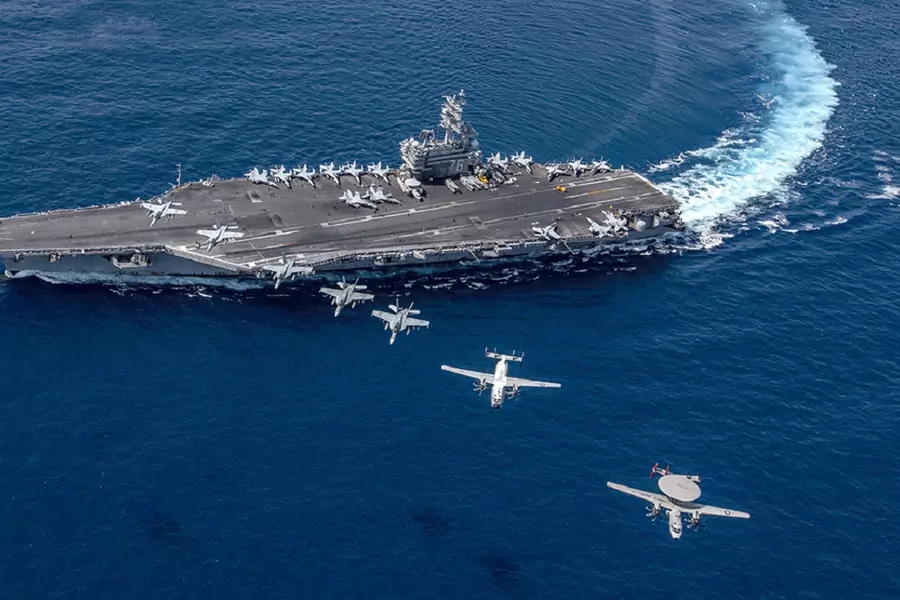 Multiple aircraft fly in formation over the USS Ronald Reagan, a U.S. Navy aircraft carrier. (Kaila V. Peters/U.S. Navy)
