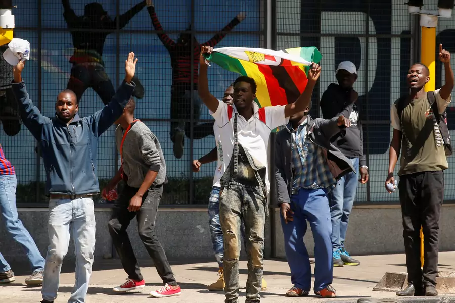 Protesters hold flags during clashes after police banned planned protests over austerity and rising living costs called by the opposition Movement for Democratic Change (MDC) party in Harare, Zimbabwe, August 16, 2019