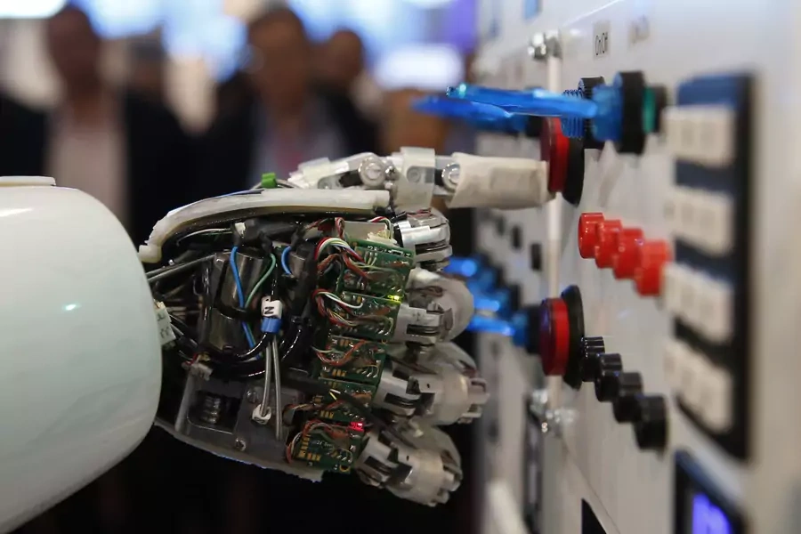 The hand of humanoid robot AILA (artificial intelligence lightweight android) operates a switchboard during a demonstration by the German research centre for artificial intelligence at the CeBit computer fair in Hanover