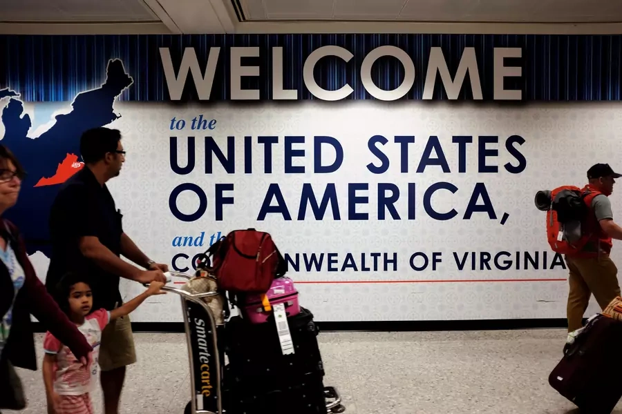 A family exits after clearing immigration and customs at Dulles International Airport in Dulles, Virginia, United States, on September 24, 2017. 