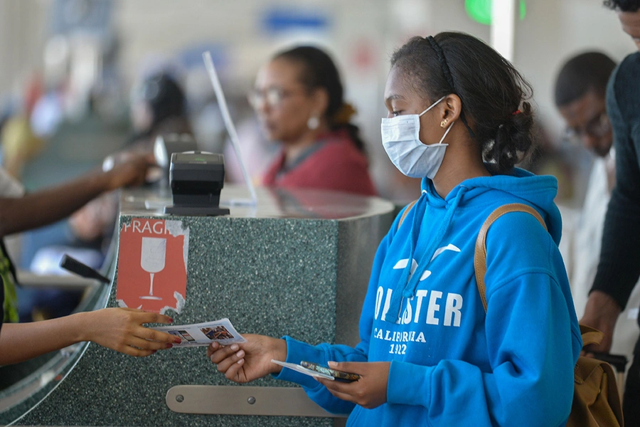 A passenger wears a mask as she waits at passport control in Bole International Airport in Addis Ababa, on January 30, 2020, following an outbreak of coronavirus in China.