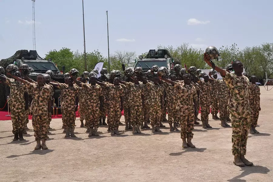 Nigerian soldiers salute during a visit by President in Maiduguri, on July 6, 2018, during the celebrations for Nigeria Army day. 