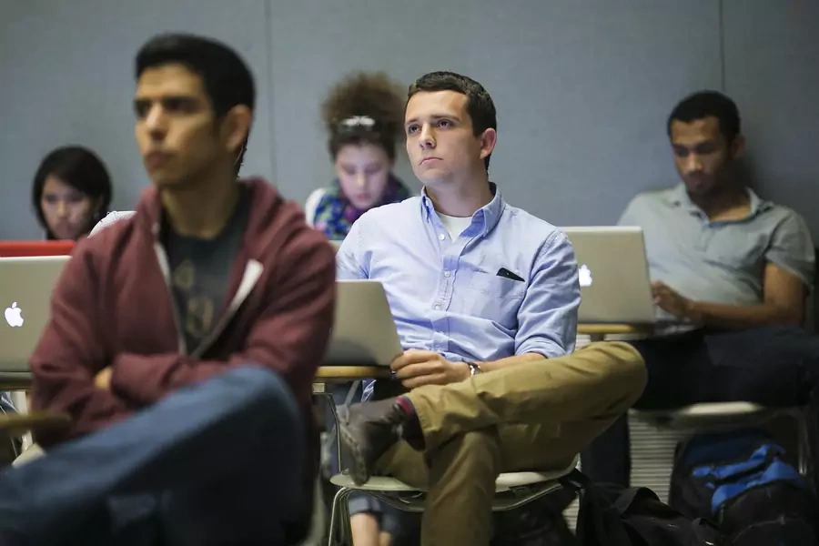 Stanford University students listen while classmates make a presentation