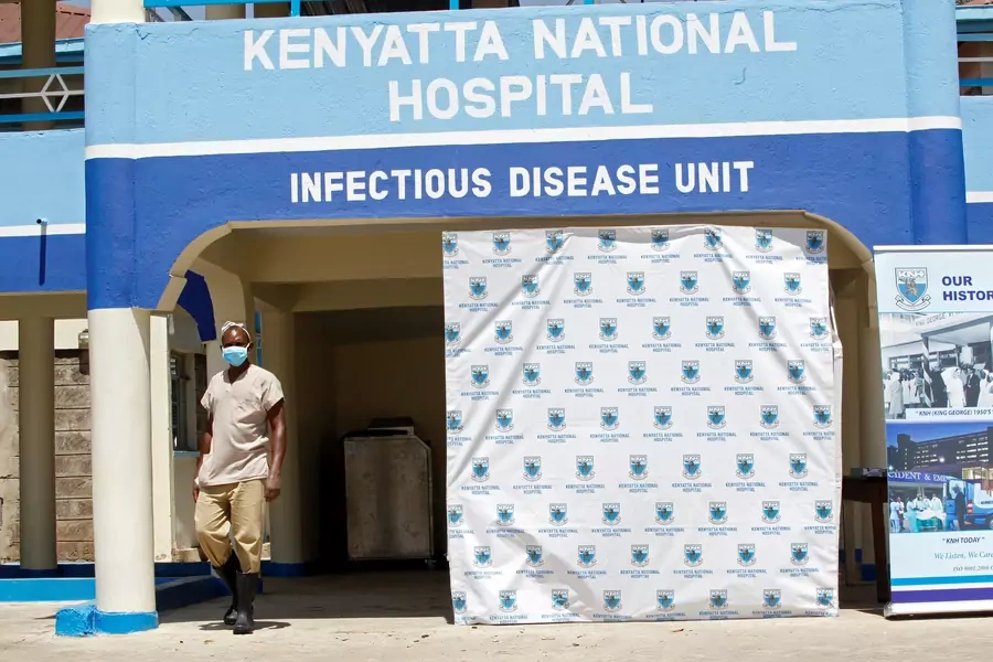 A worker walks outside the coronavirus isolation facility at the Mbagathi Hospital in Nairobi, Kenya, on March 15, 2020. 