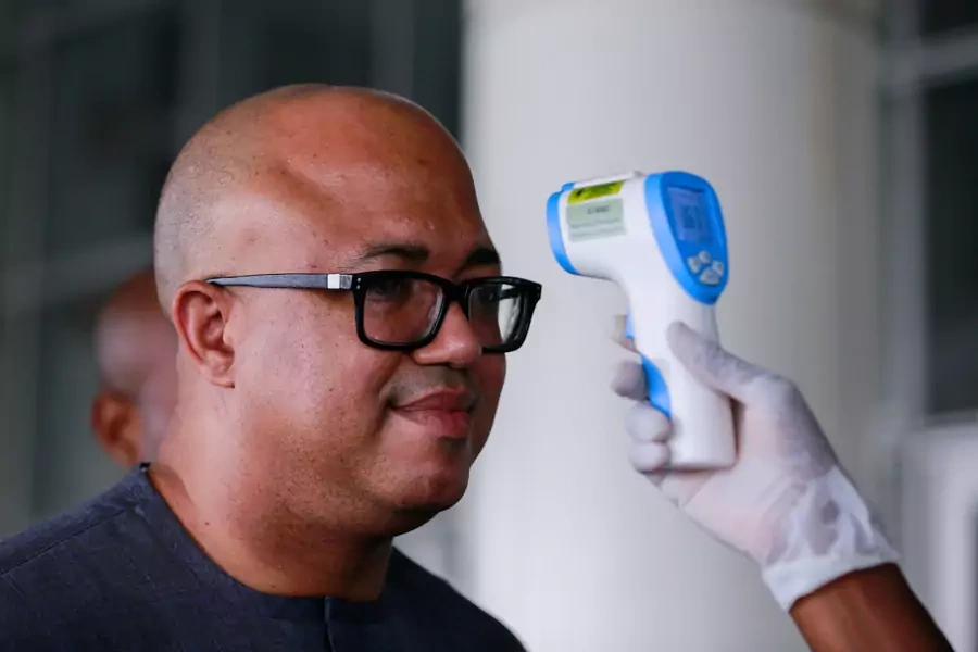 Dr. Chikwe Ihekweazu, the Director General of the Nigeria Centre for Disease Control (NCDC) has his temperature checked during a diplomatic meeting at the Ministry of Foreign Affairs in Abuja, Nigeria, on March 12, 2020