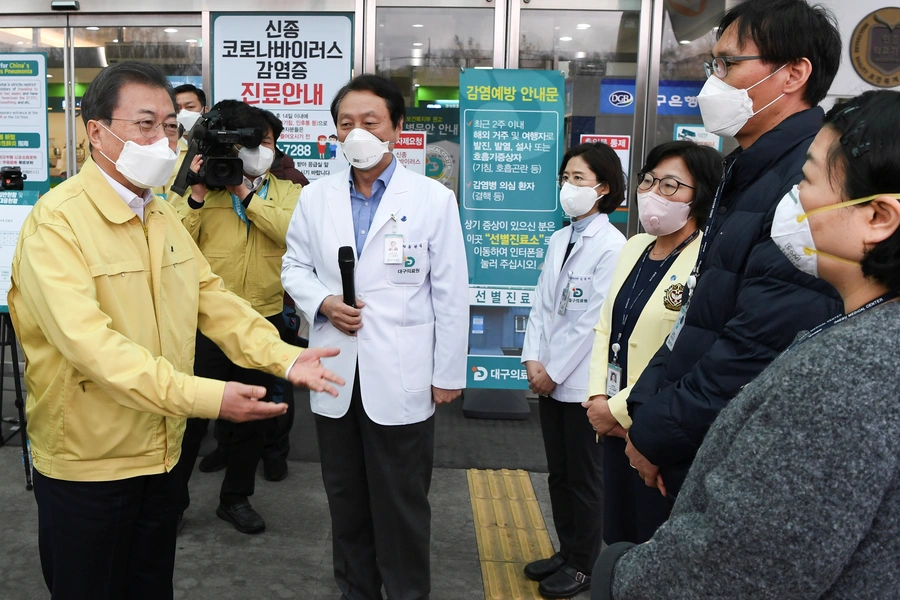 South Korea's President Moon Jae-in gets briefed during his visit to a medical center in Daegu, South Korea, on February 25, 2020.