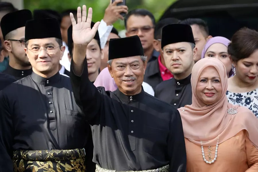Malaysia's Prime Minister Designate and former interior minister Muhyiddin Yassin waves to reporters before his inauguration as the eighth prime minister, outside his residence in Kuala Lumpur, Malaysia, on March 1, 2020.