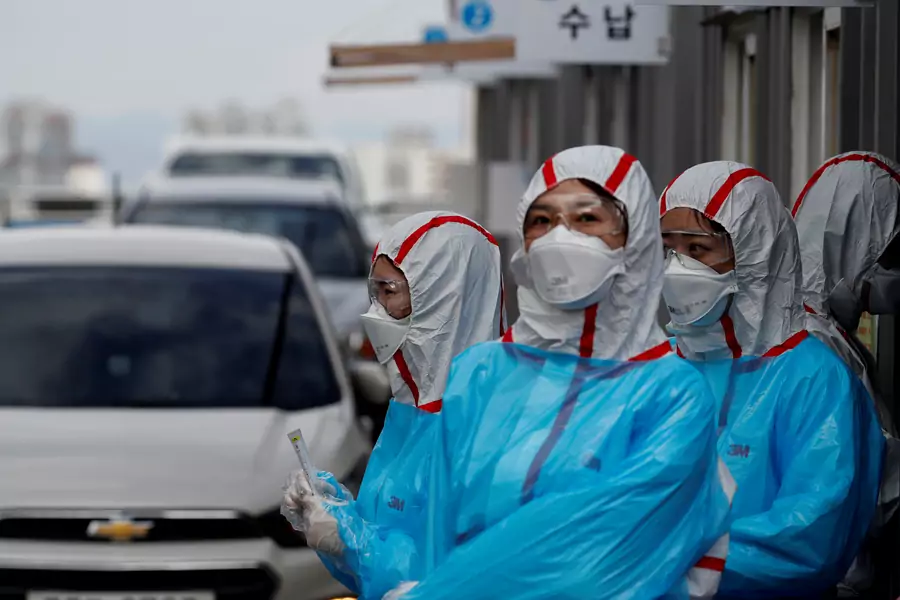 Medical staff in protective gear work at a 'drive-thru' testing center for COVID-19 in Yeungnam University Medical Center in Daegu, South Korea, on March 3, 2020.
