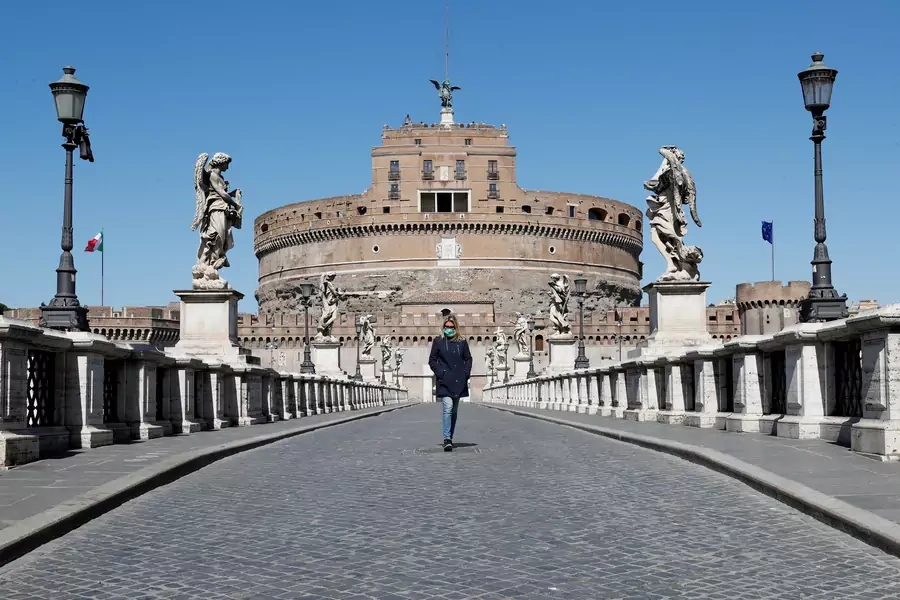 A woman wearing a protective mask outside Castel Sant'Angelo. Italy has tightened measures to try and contain the spread of COVID-19 (coronavirus). Rome, Italy. March 23, 2020.
