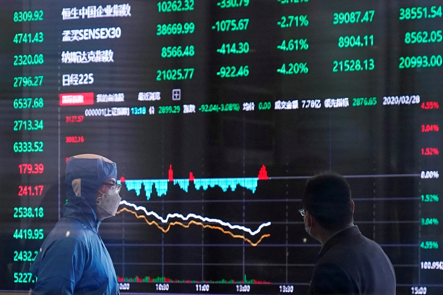 A worker wearing a protective suit is seen inside the Shanghai Stock Exchange building amid the coronavirus outbreak, at the Pudong financial district in Shanghai, China February 28, 2020.