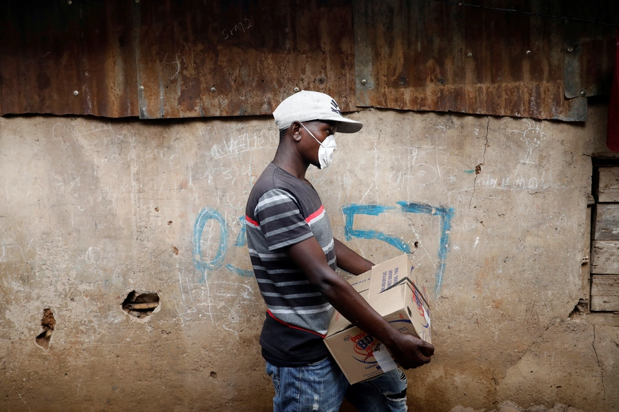 A community activist holds a box with donations to be distributed to people in need in Nairobi, Kenya, on April 14, 2020