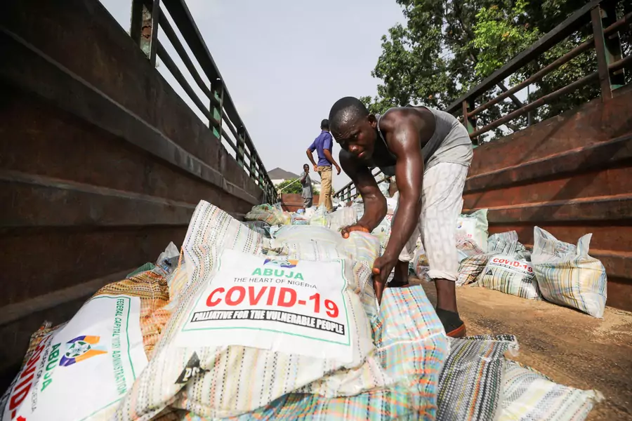 Men load sacks of rice among other food aid in a truck, to be distributed for those affected by procedures taken to curb the spread of coronavirus disease (COVID-19), in Abuja, Nigeria, on April 17, 2020.