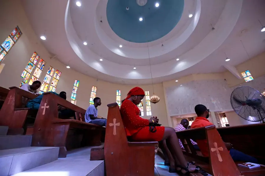 Christian worshippers sit during a mass at the St. Gabriel Catholic church, as the government struggles to control the spread of the coronavirus disease (COVID-19) in Abuja, Nigeria, on March 22, 2020. Lockdown orders were issued for March 30.