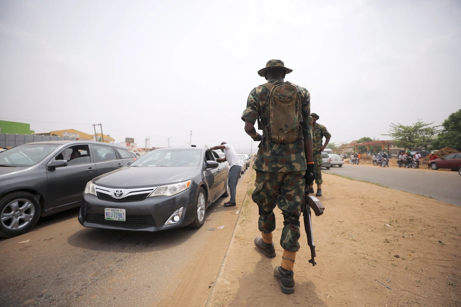 A soldier observes temperature checks at the border between Abuja and Nasarawa states in Nigeria, as the authorities try to limit the spread of the coronavirus disease (COVID-19), on March 30, 2020. 