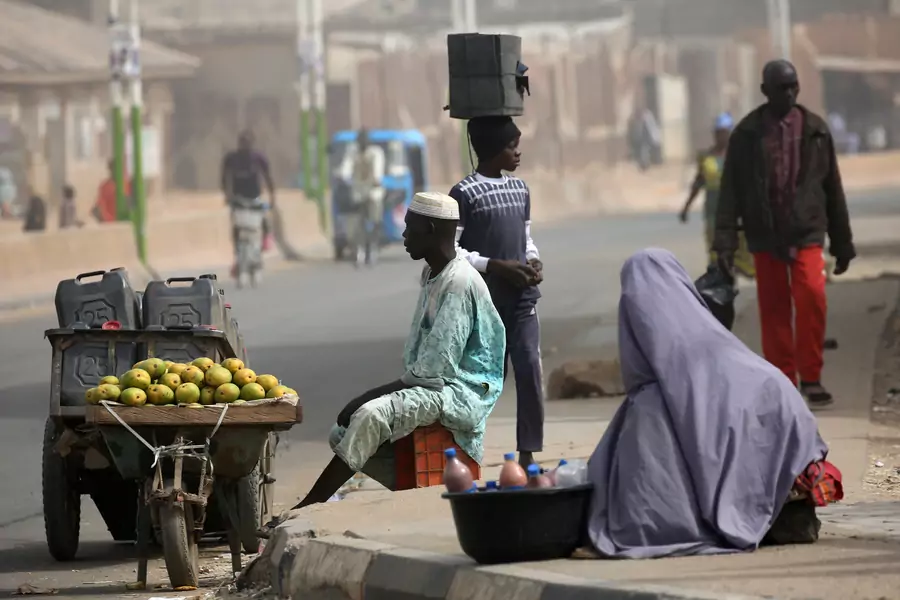 Street vendors sell fruit and other goods after the postponement of the presidential election in Kano, Nigeria, on February 17, 2019